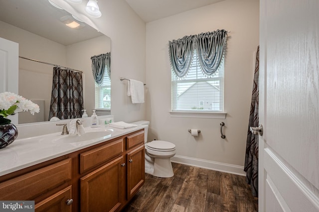 24840 Mistletoe Dr, Georgetown, DE 19947 - full bathroom featuring vanity, toilet, wood finished floors, baseboards, and curtained shower