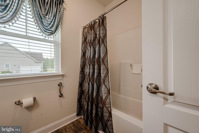 24840 Mistletoe Dr, Georgetown, DE 19947 - bathroom featuring shower / tub combo, wood finished floors, and baseboards