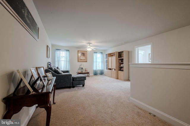 24840 Mistletoe Dr, Georgetown, DE 19947 - living room featuring light colored carpet, baseboards, and ceiling fan