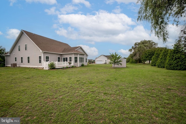 24840 Mistletoe Dr, Georgetown, DE 19947 - rear view of house with a lawn, a deck, and central AC