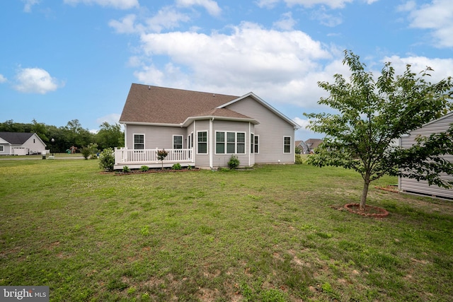 24840 Mistletoe Dr, Georgetown, DE 19947 - back of house featuring a yard, a wooden deck, and roof with shingles
