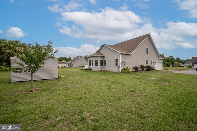24840 Mistletoe Dr, Georgetown, DE 19947 - view of side of home with a lawn, driveway, and roof with shingles