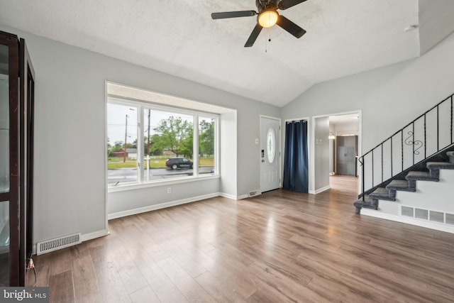 197 Lincoln Ave, Paulsboro, NJ 08066 - unfurnished living room with vaulted ceiling, ceiling fan, stairs, wood finished floors, and baseboards