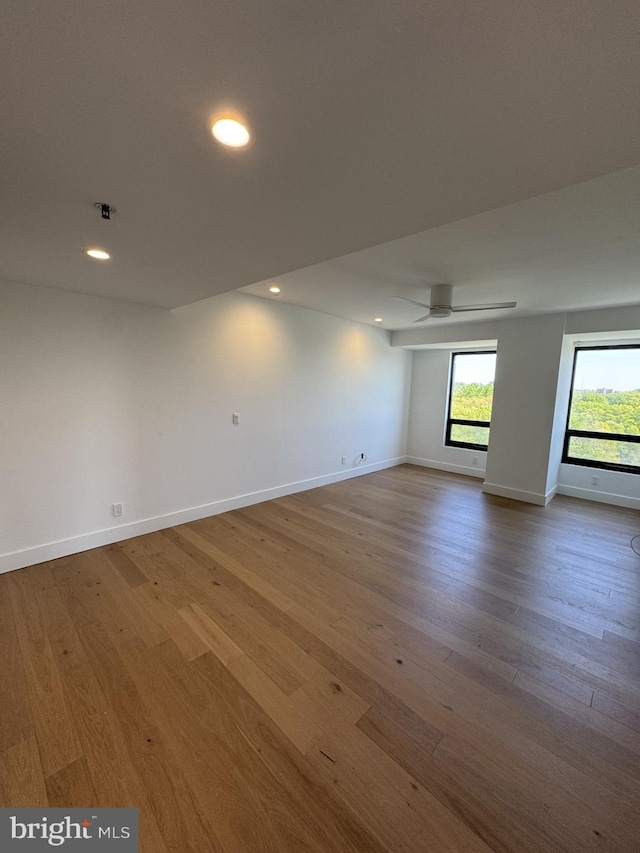 unfurnished room featuring recessed lighting, a ceiling fan, baseboards, and wood finished floors