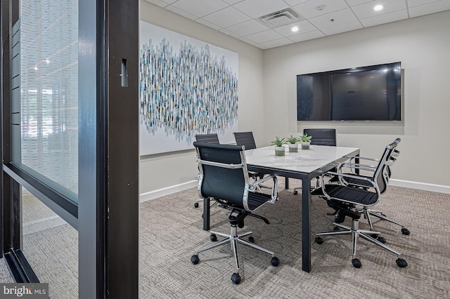carpeted home office with baseboards, a paneled ceiling, and visible vents