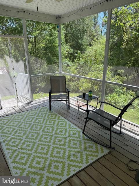 wooden terrace featuring ceiling fan