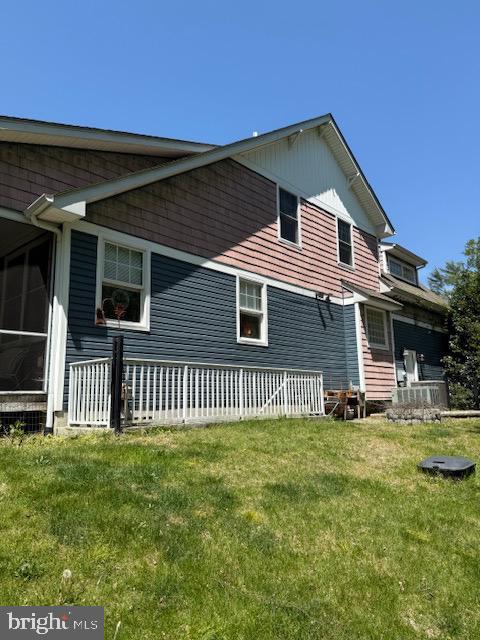 back of house with a lawn