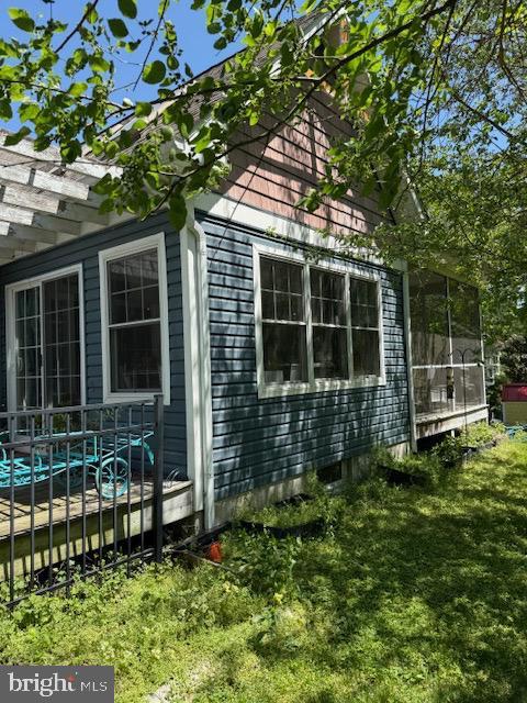 view of side of home with a yard and a pergola