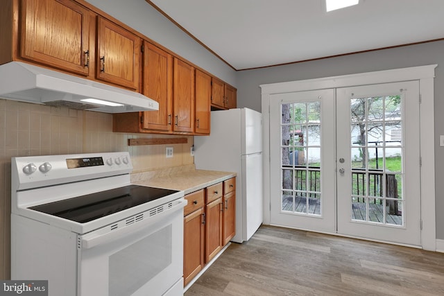 kitchen featuring white appliances, light countertops, under cabinet range hood, brown cabinets, and french doors