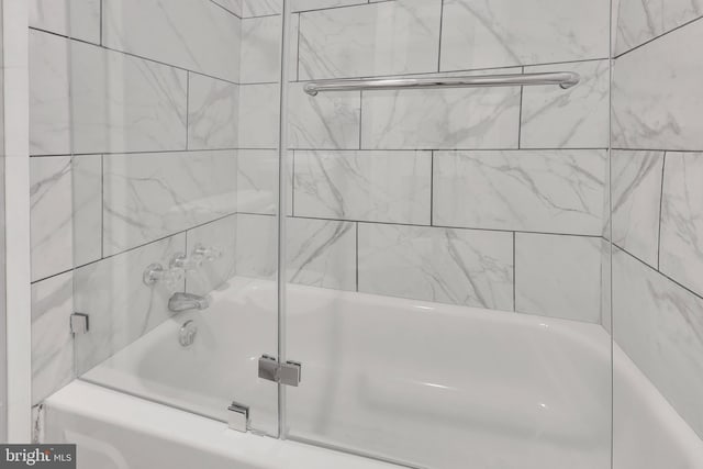 full bath featuring combined bath / shower with glass door