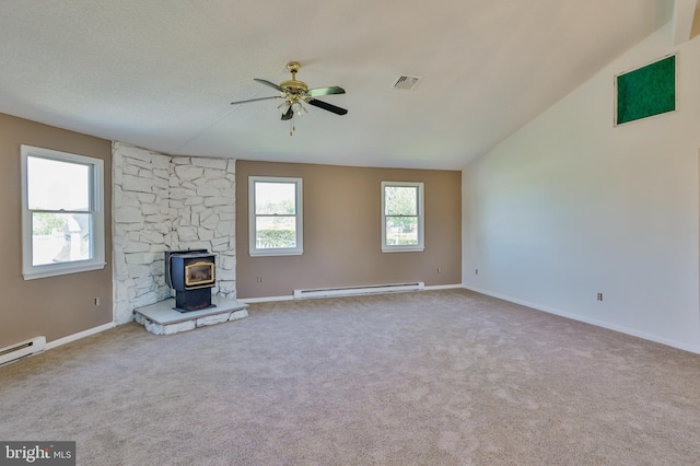 3 Dusty Rd, Easton, PA 18045 - unfurnished living room featuring visible vents, a wood stove, ceiling fan, a baseboard heating unit, and carpet