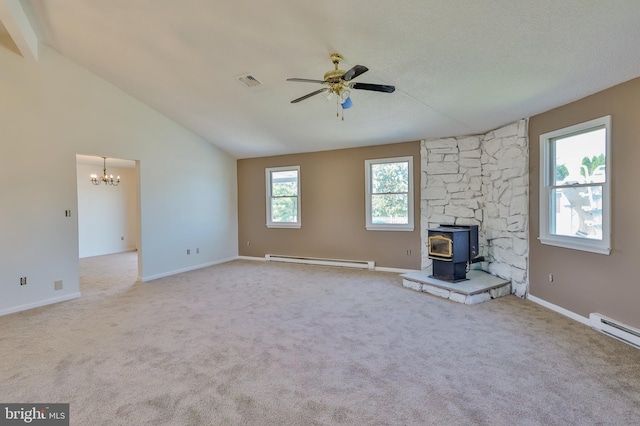 3 Dusty Rd, Easton, PA 18045 - unfurnished living room with baseboard heating, a wood stove, ceiling fan with notable chandelier, lofted ceiling, and visible vents