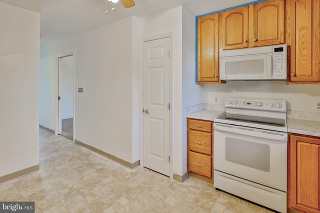 3 Dusty Rd, Easton, PA 18045 - kitchen with white appliances, baseboards, light countertops, brown cabinets, and a ceiling fan