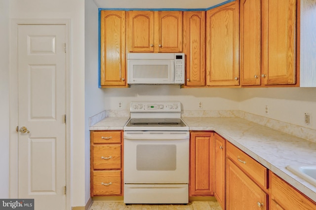 3 Dusty Rd, Easton, PA 18045 - kitchen featuring light countertops, brown cabinetry, and white appliances
