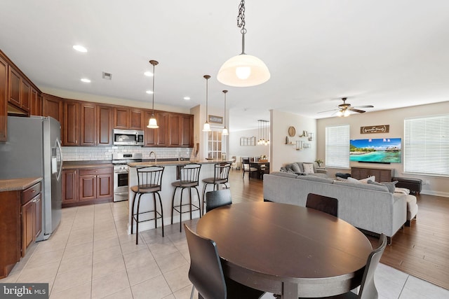 dining space featuring a ceiling fan, recessed lighting, light tile patterned flooring, and visible vents
