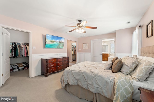 bedroom featuring visible vents, a walk in closet, and a closet