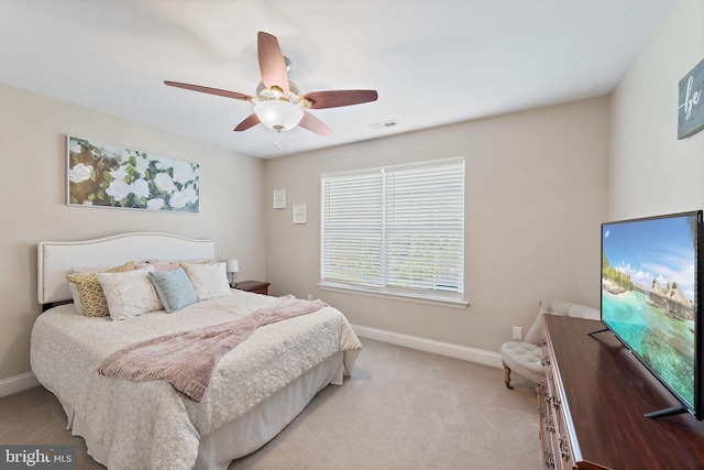 bedroom with a ceiling fan, baseboards, visible vents, and light carpet