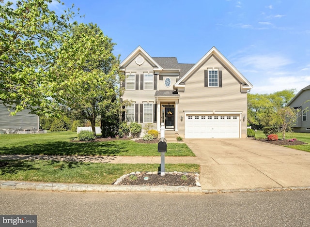 traditional-style house with concrete driveway, a front yard, and a garage