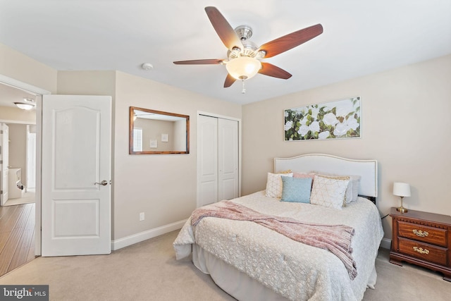 bedroom with a closet, carpet, baseboards, and a ceiling fan