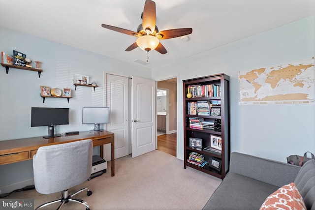 office area featuring light colored carpet and ceiling fan