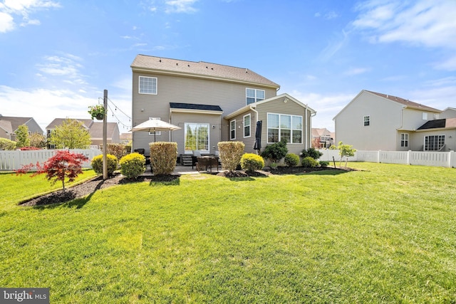 rear view of property with a lawn, a patio, fence, and a residential view