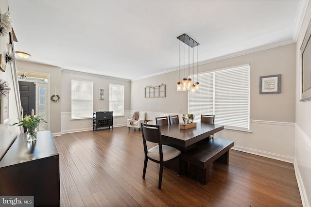 dining area with crown molding, baseboards, an inviting chandelier, and dark wood-style flooring