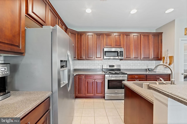 kitchen with backsplash, appliances with stainless steel finishes, a sink, recessed lighting, and light tile patterned flooring