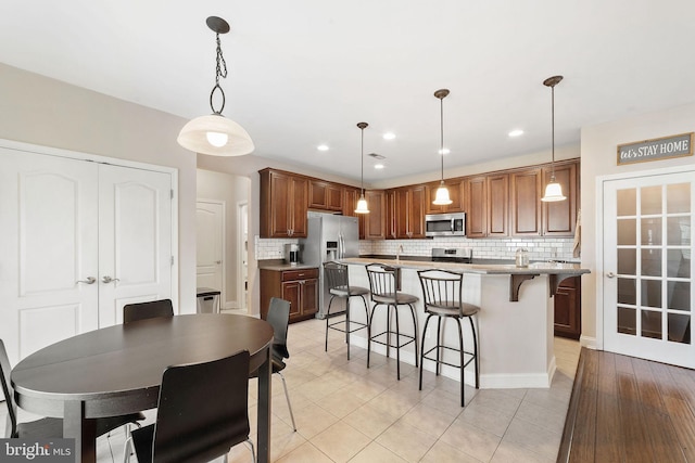dining room with recessed lighting and light tile patterned floors