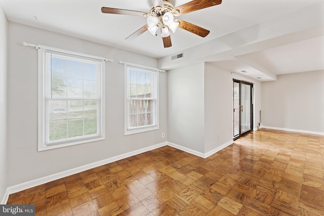 spare room featuring a ceiling fan, baseboards, and visible vents