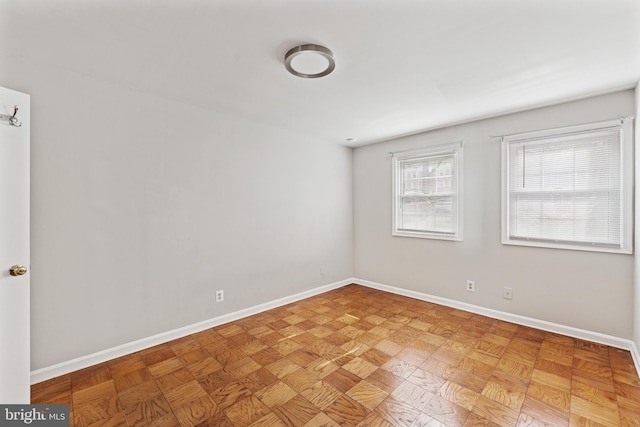 unfurnished room featuring baseboards