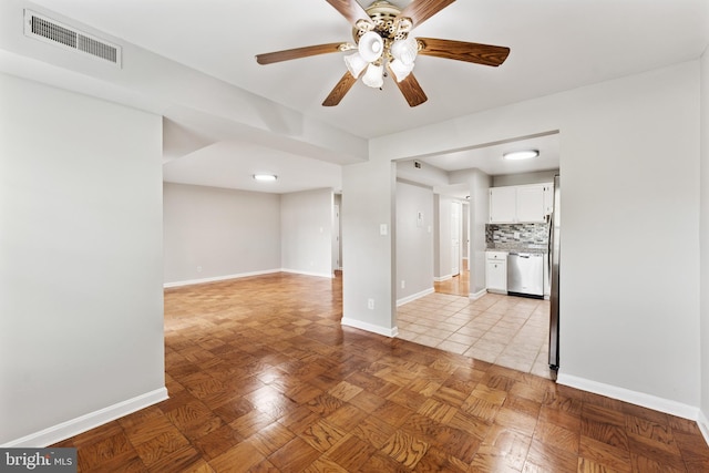 unfurnished living room with visible vents, baseboards, and ceiling fan