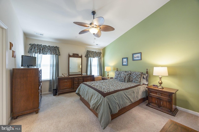 bedroom featuring baseboards, visible vents, light carpet, and vaulted ceiling