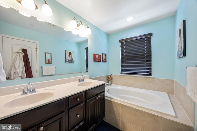 full bath featuring double vanity, visible vents, a sink, and a garden tub