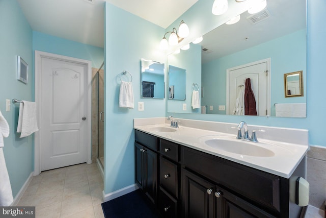 full bathroom with a sink, baseboards, a stall shower, and visible vents