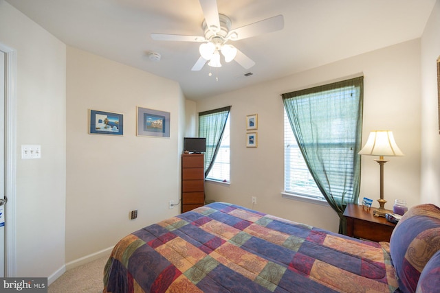bedroom with baseboards, ceiling fan, carpet flooring, and visible vents
