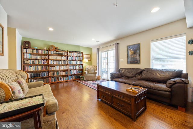living area with recessed lighting and wood finished floors