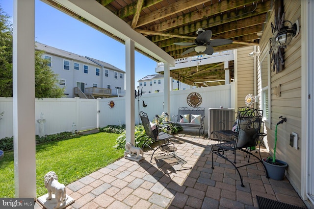 view of patio / terrace with a fenced backyard, ceiling fan, and a residential view