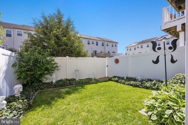view of yard featuring a residential view and a fenced backyard