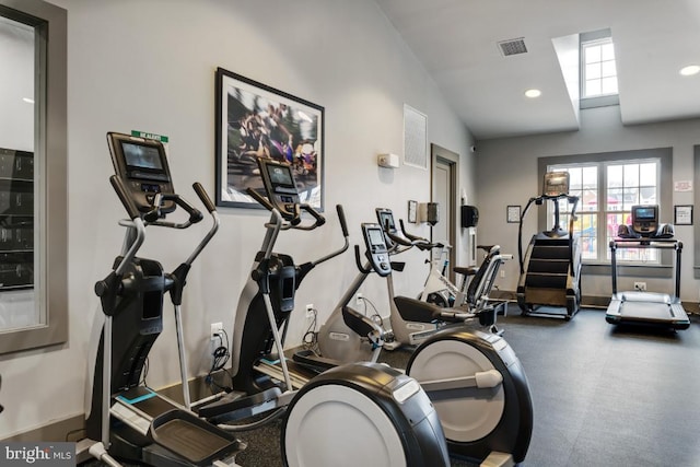 workout area with vaulted ceiling and visible vents