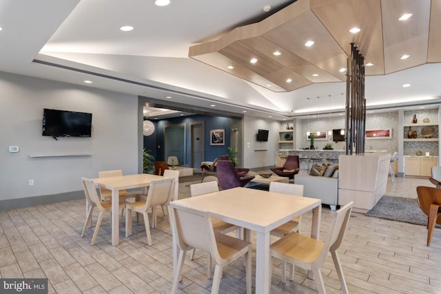 dining room featuring recessed lighting, baseboards, light wood finished floors, and lofted ceiling