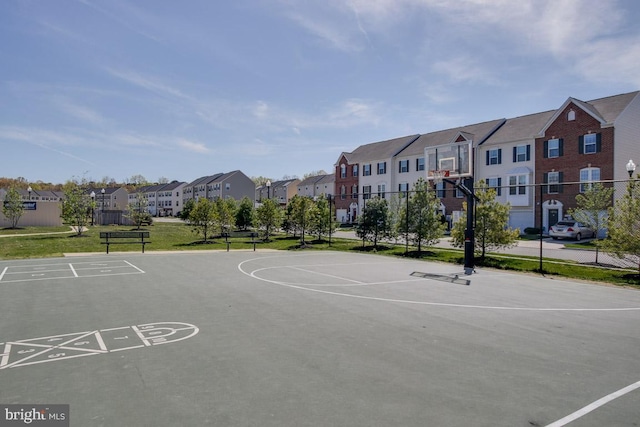 view of basketball court with community basketball court, fence, and a residential view