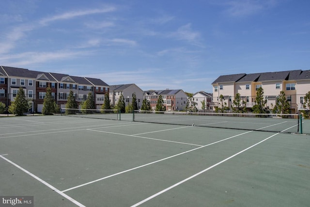 view of sport court featuring fence and a residential view