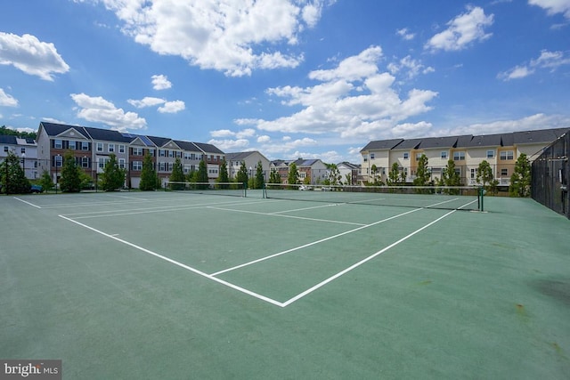 view of sport court with a residential view, fence, and community basketball court