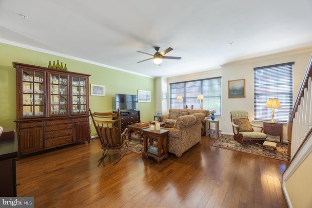 living room featuring crown molding, baseboards, a ceiling fan, and hardwood / wood-style flooring