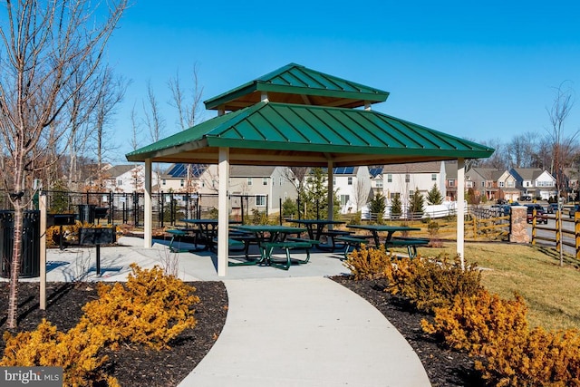 view of community featuring a gazebo, fence, and a residential view