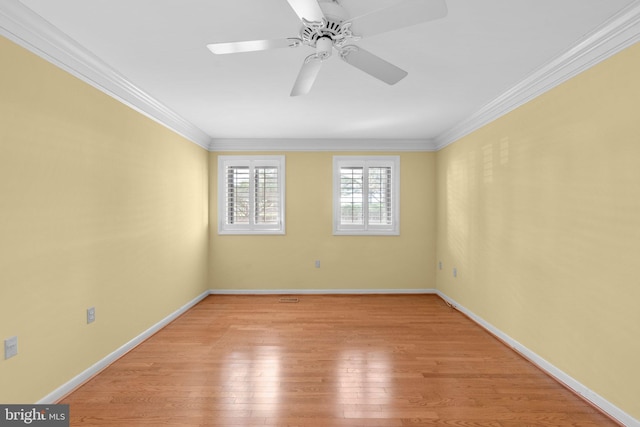 spare room with baseboards, ornamental molding, light wood-type flooring, and ceiling fan
