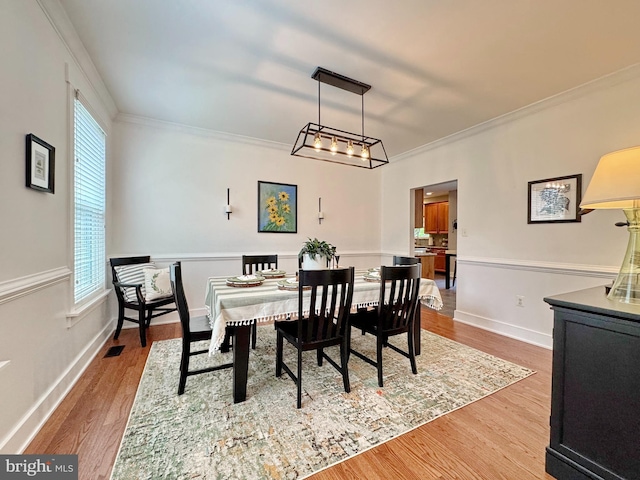 1351 Matthew Dr, Huntingtown, MD 20639 - dining space featuring crown molding, plenty of natural light, wood finished floors, and baseboards