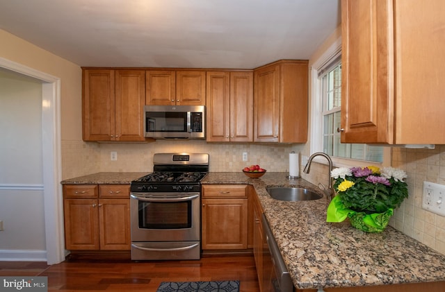 3004 Joshua Rd, Lafayette Hill, PA 19444 - kitchen with a sink, brown cabinets, stainless steel appliances, and dark wood finished floors
