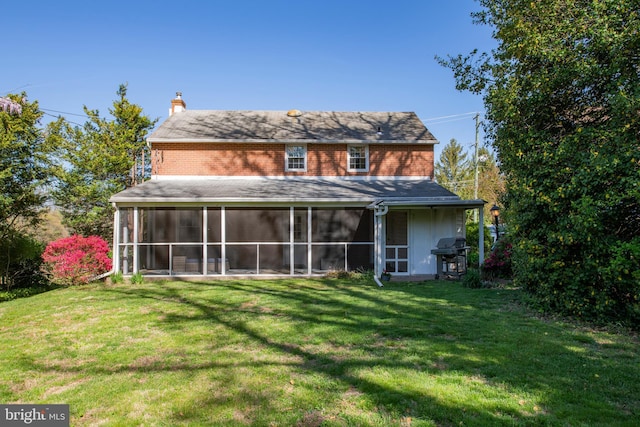 3004 Joshua Rd, Lafayette Hill, PA 19444 - rear view of property featuring a lawn, roof with shingles, a chimney, and a sunroom