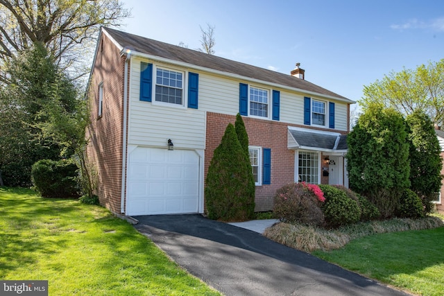 3004 Joshua Rd, Lafayette Hill, PA 19444 - view of front of home with a front lawn, aphalt driveway, a chimney, brick siding, and an attached garage